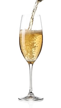 Golden champagne being poured into an elegant flute glass with sparkling bubbles and foam. Luxurious festive drink. Isolated on white background.