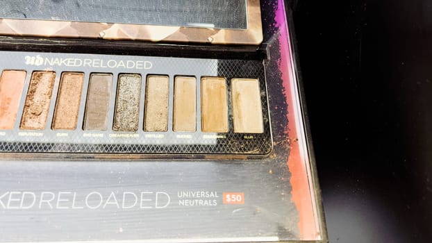 Denver, Colorado, USA-December 31, 2023-Beauty products are displayed with sophistication, featuring shimmering blush palettes, elegant lipsticks, and sleek foundations, reflecting luxury in the store mirrors.