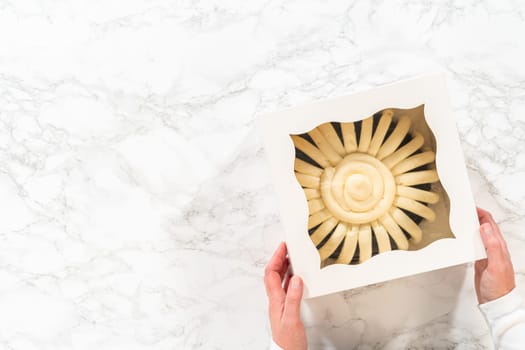 Flat lay. With care, the Chocolate Bundt Cake is packaged into a white paper box - ready for gifting to bring joy and indulgence to someone special.