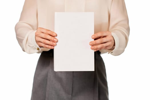 woman in white shirt showing book isolated on white background