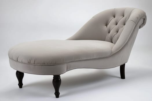 Soft gray chaise lounge featuring a tufted backrest and sleek curves, perfect for enhancing contemporary living spaces.