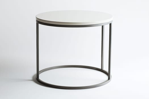 A sleek round table features a simple white top and a sturdy metal frame, perfect for contemporary interiors or casual gatherings.