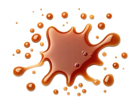 Close-up of a brown liquid splash with droplets scattered around. Glossy and smooth texture, perfect for coffee, caramel, or syrup concepts. Isolated on white background.