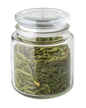 Dried green tea leaves stored in a transparent glass jar with a sealed lid. Organic, fresh, and aromatic. Isolated on white background