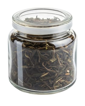 Dried oolong tea leaves stored in a transparent glass jar with a sealed lid. Traditional loose leaf tea for brewing. Isolated on white background