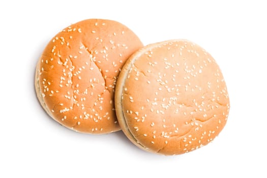 Empty burger bun with sesame seeds isolated on a white background.