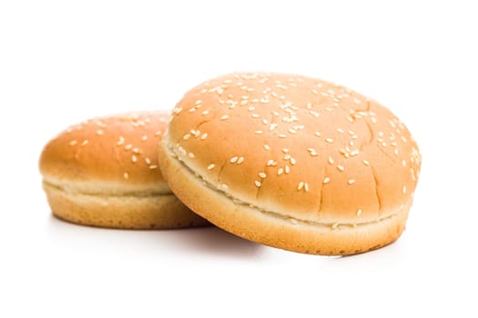 Empty burger bun with sesame seeds isolated on a white background.
