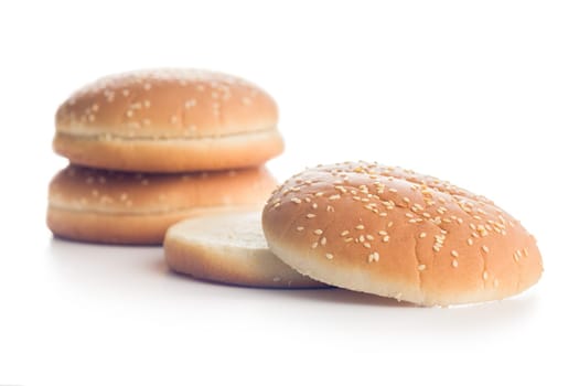 Empty burger bun with sesame seeds isolated on a white background.