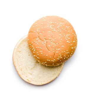 Empty burger bun with sesame seeds isolated on a white background.