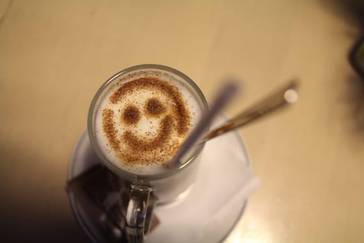 Imagine a delightful cup of coffee topped with beautiful smiley foam art, which is perfect for brightening your day