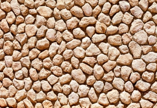Wall made of cobblestones, close up, for background or texture