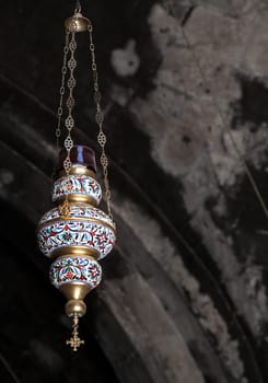This is a beautifully designed hanging lantern that features intricate patterns along with rich and vibrant colors