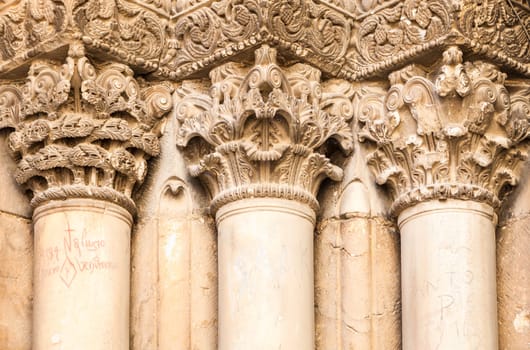 This image features a detailed closeup view of a row of beautiful columns on an impressive architectural building structure