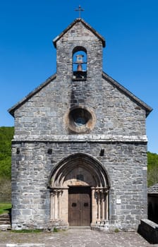 In the French Pyrenees, a charming stone chapel softly chimed, welcoming weary travelers on the Camino de Santiago.
