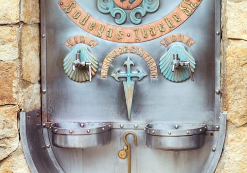 Pilgrims on the Camino de Santiago enjoy free wine from Fuente del Vino, a refreshing stop along their journey.