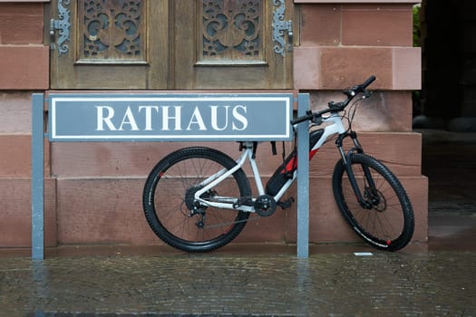 Wuerzburg, Germany – September 26, 2024: Sign and bicycle in front of the town hall of Wuerzburg in Germany