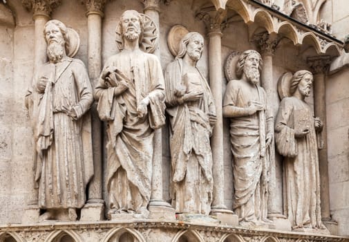 Intricate stone sculptures of religious figures enhance the architecture of the Burgos Cathedral, showcasing artistry.