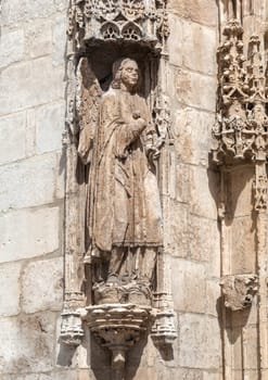 Intricate stone sculptures of religious figures enhance the architecture of the Burgos Cathedral, showcasing artistry.