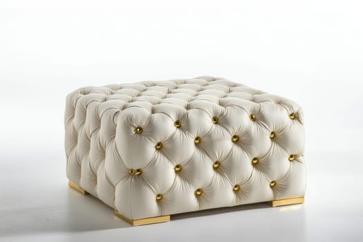 This stylish tufted ottoman showcases a luxurious design with gold accents, perfect for modern interior decor in any space.