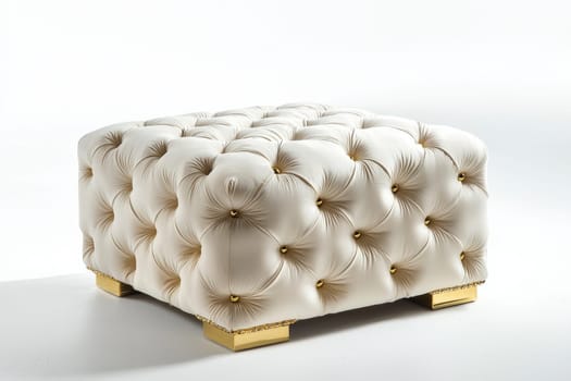 This stylish tufted ottoman showcases a plush design, featuring gold accents that enhance contemporary living spaces.