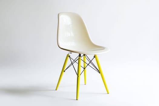 A contemporary chair features a glossy white seat and yellow legs, showcasing modern design in a minimalist setting with ample light.