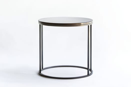 This round table features a sleek design with a black top and minimalistic metal legs, ideal for contemporary living spaces.