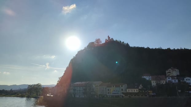 River sunlight castle blue sky landscape background summer day evening landscape city centre nature water. October 16 2024 Decin Czech Republic Europe travel places . High quality photo