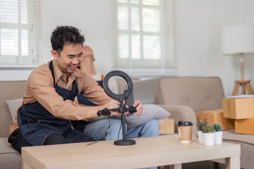A dedicated online seller prepares a ring light for video content creation, highlighting the importance of technology in business.