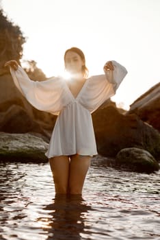 A woman standing next to a body of water. High quality photo