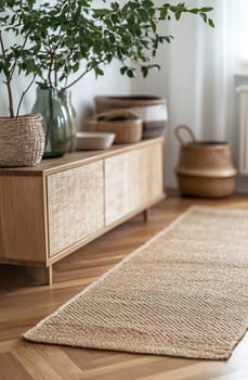 A cozy living space features a wooden cabinet, decorative plants, and woven baskets, creating a warm atmosphere in natural light.