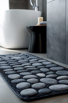 A stylish bathroom features a textured stone bath mat next to a sleek bathtub and minimal decor, creating a relaxing atmosphere.