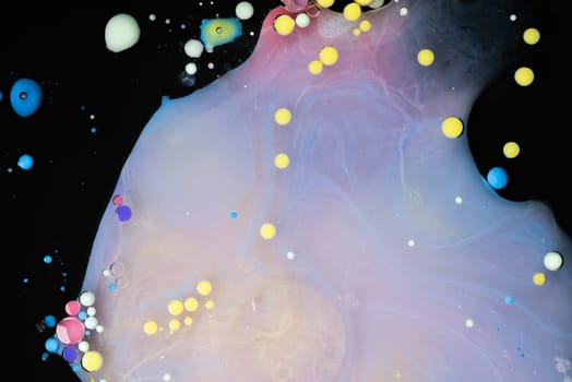 A myriad of oil droplets intermingling with water, creating a mesmerizing effect reminiscent of a galaxy.