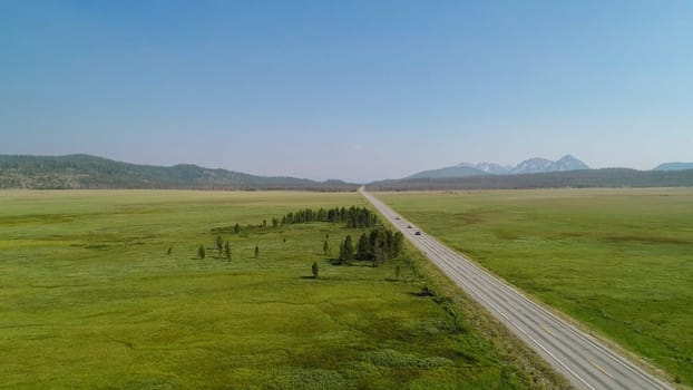 aerial view of a road against a green valley as seen from a drone or a birds eye view