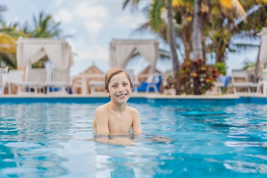 A young boy joyfully swims in a tropical pool surrounded by lush greenery. The vibrant scene captures the essence of summer fun, adventure, and carefree childhood moments in a refreshing outdoor setting.
