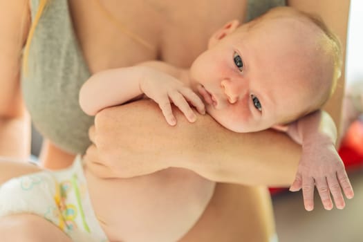 A mother lovingly embraces her newborn baby, holding them close to her chest. A tender moment of warmth, security, and deep maternal love, symbolizing bonding, comfort, and the unbreakable connection between mother and child.