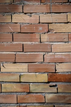 Layers of worn bricks reveal a beautiful blend of earthy tones in a cozy, quiet corner of the city.