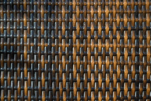 Delicate interlacing of dark and light strands forms a textured backdrop reflecting natural warmth and artistry.