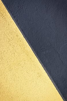 A vibrant interplay of yellow and dark surfaces generates a captivating visual contrast in an artistic setting.