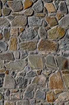 Roughly arranged stones showcase earthy colors and varying shapes, highlighting craftsmanship in a historical setting.