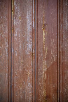 Textured red wood panels evoke warmth and nostalgia, creating a cozy backdrop for artistic creativity and inspiration.