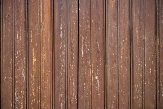 Rich brown tones and textured surfaces of vertical wooden planks evoke a sense of warmth and natural beauty.