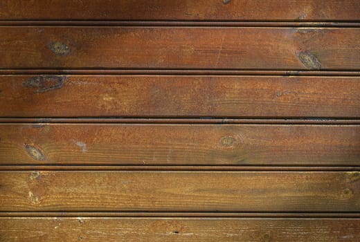Wooden panels exhibit a warm, rustic charm as gentle light enhances their natural grain and colors.