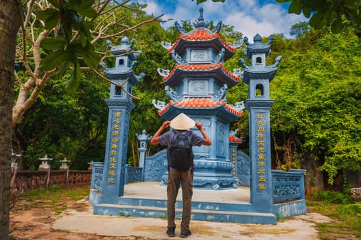 male tourist traveler at the temple on Buddhist pagoda in Da Nang, Vietnam. Travel and tourism in Asia
