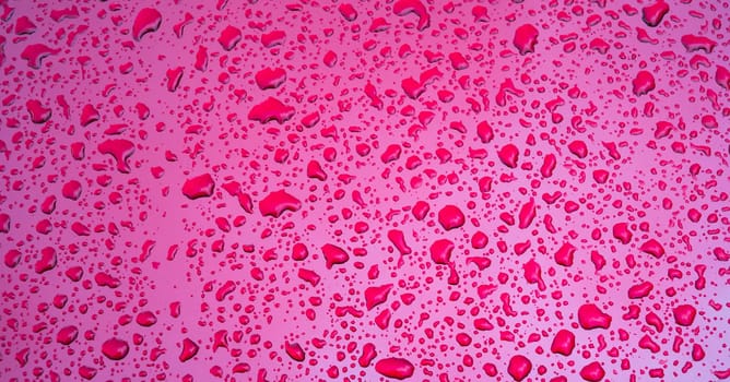 abstract red background with the texture of rain drops on a metal surface close-up
