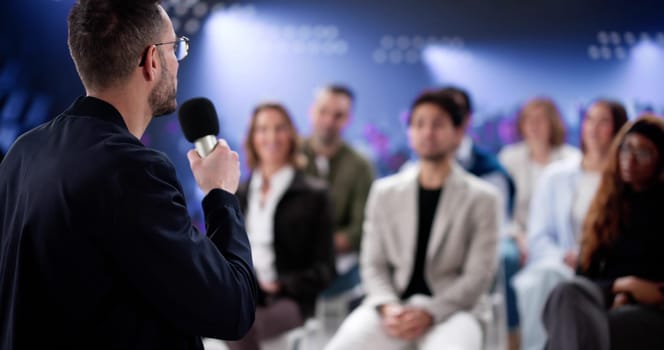 Engaging Speaker Captivates Diverse Audience at Business Conference Event.
