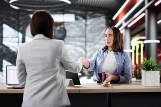 Hotel Receptionist Welcoming Businesswoman, Arranging Check-In for Traveling Entrepreneur.
