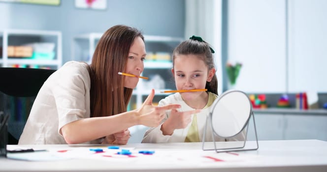 Improving oral motor skills with tongue depressors in speech therapy.