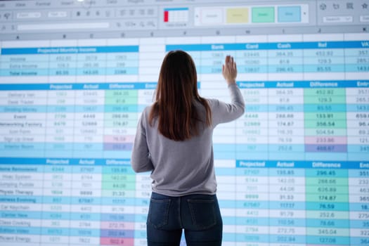 Young businesswoman using spreadsheet to calculate medical billing records accurately.