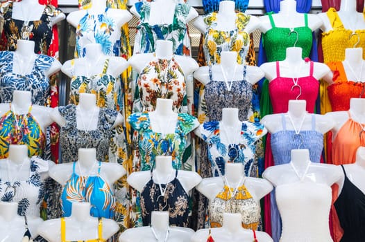 female summer dresses on mannequins on the market bazaar in Asia textile clothes shop