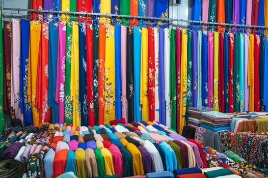 clothing and fabrics at the textile market bazaar in Asia in Vietnam
